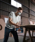 Man using Real Deal 18V Cordless Jigsaw Packing Brushless Muscle And Quick Swap Blades for curved cuts in wood.
