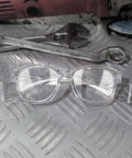 Anti Fog Safety Glasses With Side Shields And All Day Comfort For Work And Home ANSI Z87 1 Rated Eye Protection With UV Shield And Everyday Hustle Ready For Any Task displayed on a textured surface with tools in background