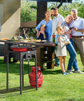 Family enjoying barbecue outdoors with 100,000 BTU Portable Gas Camping Stove With Regulator For Outdoor Cooking