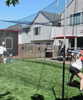 Four By Six Foot Batting Cage Backstop Net With Strike Zone Target For Baseball And Softball Pitching Practice In The Backyard Heavy Duty 600D Oxford Fabric With Eight Bungee Cords For Youth And Beginners Training Net set up in backyard.