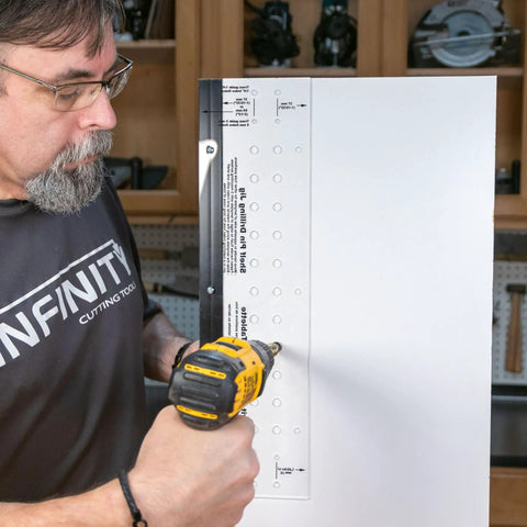 Person using Beefy Shelf Pin Jig For Adjustable Shelves And Cabinets, 19-Inch Aluminum Spine, Dual-Row Indexing With 1.25 Inch Hole Spacing