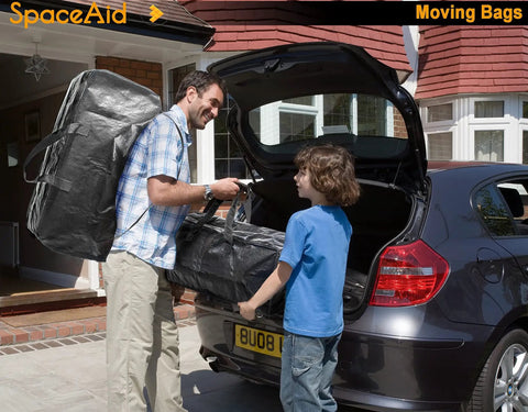 Man and child loading Heavy Duty Moving Bags Extra Large Storage Totes With Backpack Straps into a car trunk in driveway.