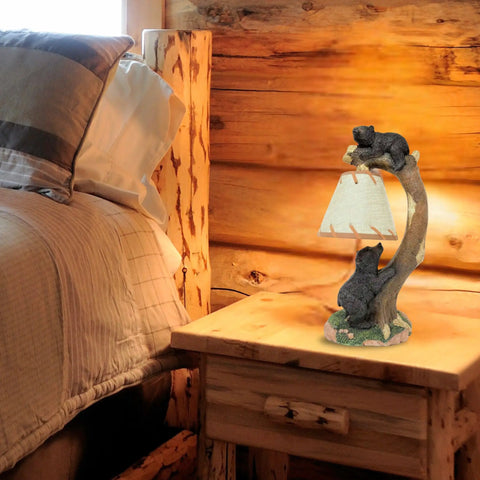 Cozy Cabin Vibes Table Lamp With Hand Painted Tree Climbing Bears Night Light on a rustic nightstand in a log cabin bedroom.