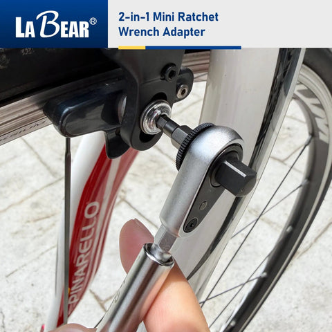 2-In-1 Mini Ratchet Wrench Adapter With Magnetic One Quarter Inch Hex Bit Holder And One Quarter Inch Drive Socket Adapter in use on bike