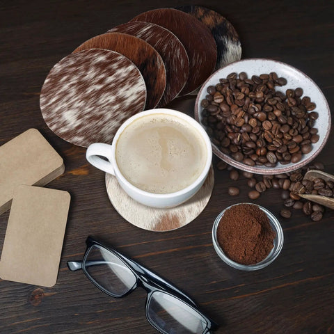 Premium Round Cowhide Coasters Set Of Twelve Natural Leather Drink Mats Ultra Smooth Finish with coffee and beans.