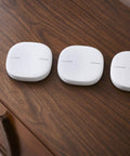 Three white units of All-In-One SmartThings WiFi Mesh Router And Hub For Whole Home Coverage With Zigbee And Z-Wave, ET WV525KWEGUS