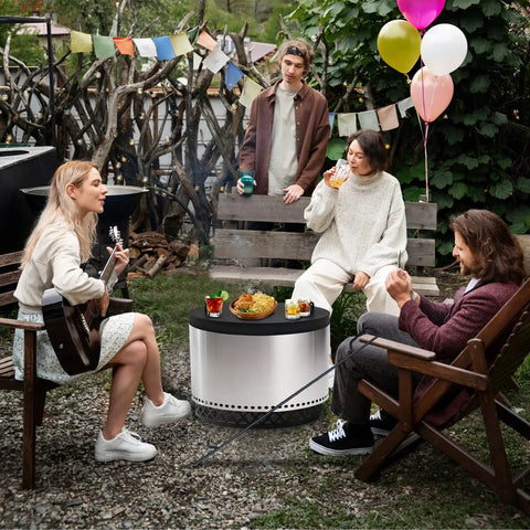 Group enjoying outdoor gathering with Smokeless Fire Pit Accessories Kit With 23-Inch Carbon Steel Base, 36-Inch Fire Poker, And 27.5-Inch Lid With Dual Wood Handles, Yukon Solo Stove Compatible, Great For Camping, Patio, And Backyard Use.