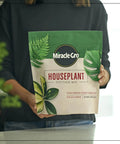 Top Shelf 4 Quart Indoor Plant Potting Mix Loaded With Fast Feeding Fertilizer Keeps Your Container Houseplants Poppin Without Any Drama While Fueling Bold New Leaves Through Spring And Summer in a person's hands.