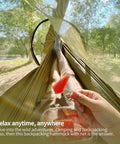 Person relaxing in Lightweight One Person Hammock With Mosquito Net Easy Setup Portable Camping Hammock in olive 70D nylon.
