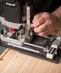 Rock Solid Trim Base For Hardwood Lipping Quick Swap Router Adapter on wood, demonstrating accurate trimming and routing tasks.