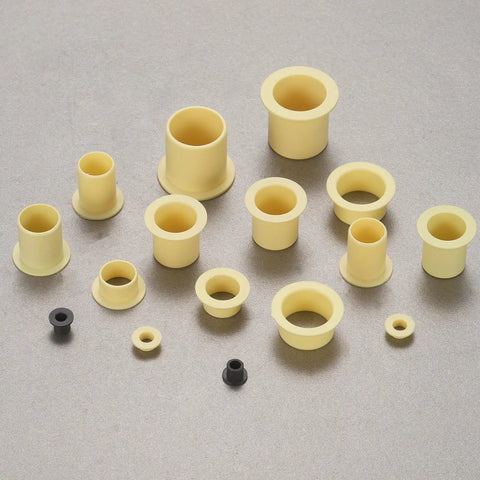 Four Piece Pack Of Precision Flanged Sleeve Bearings Crafted From High Grade Pom Plastic Providing Smooth As Butter Spin And A Dead Nuts Tight Fit For Hobbyist Builds And Equipment Repair Jobs, assortment of small yellow flanged bushings.