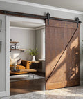Heavy Duty Sliding Barn Door Hardware Kit With Reinforced Steel Rollers And Silent Tracks, showcasing a wood door and matte black rail in a stylish interior.
