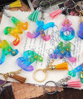 Colorful resin keychains shaped as letters with tassels, part of the 233 Piece Craft Toolkit Featuring Electric Hand Drill And Precision Bits For Resin Art And Keychain Making Includes Flat Nose Pliers Jump Rings And Screw Eyes Total Game Changer For Knocking Out Dope Jewelry.