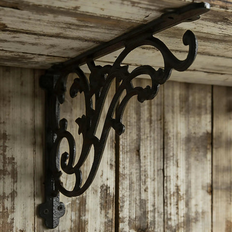 16 Inch Cast Iron Shelf Brackets 4 Pack Black Corbels Built Different Heavy Duty Wall Mounted Shelf Supports Up To One Hundred Pounds With Mounting Hardware side view detailing ironwork design