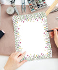 Person writing on 60 Sheets Watercolor Floral Letterhead Paper With Wildflower And Butterfly Border Double Sided Writing Paper For Notes