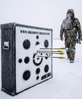 Iron Man 30 Inch Archery Target For Personal Range, 475 FPS Rated beside hunter in snow, arrows embedded in target.