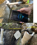 50W Pipeline Spiral Hydroelectric Generator in stream, charging phone via USB 3.0, shows 60% charge, ideal for off-grid use.