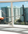Built Like A Tank 30 Inch Silicone Floor Squeegee With Rust Resistant Stainless Aluminum Pole cleaning a large window.