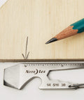Silver Carabiner Key Clip One And Eleven Sixteenth Inch with measurement scale next to a pencil on wooden surface