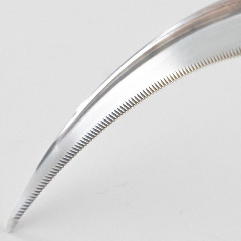 Close-up of sharp saw-tooth blade on a garden sickle for no-fuss weeding and harvesting grass weeds and perennials, made in Japan.