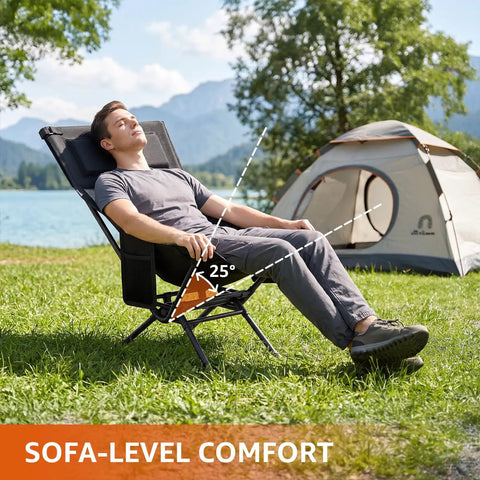 Person reclining on an Armless Rocking Camping Chair With Spring Action Tech by a tent and lake, demonstrating comfort angle.