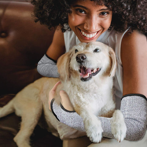 Person with dog wearing cut resistant arm sleeves for work and gardening, protective arm protectors for men with thumb hole.