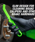 Gloved hand using slim steel wire brush for brake calipers with angled head for tight spots and rust removal on brake rotor