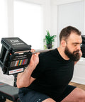 Man lifting Pro 100 Straight Bar For Adjustable Dumbbell System Convert Your Dumbbells Into A True Barbell in home gym setting