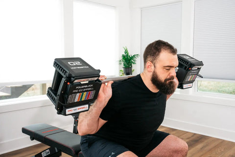 Man lifting Pro 100 Straight Bar For Adjustable Dumbbell System Convert Your Dumbbells Into A True Barbell in home gym setting