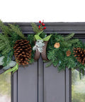 Heavy Duty Adjustable Front Door Garland Hanger With Padded Ends Providing Rock Solid Grip On Jambs From 51 To 81 Inches Holding 20 Lbs Of Decor For Zero Stress Holiday Setup with festive garland on a door.