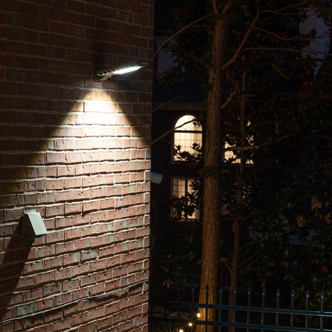 6 Watt Outdoor Solar Area Light With PIR Motion Sensor And Timer Bright White Security Light illuminating a brick wall at night