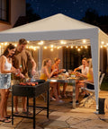 Group enjoying a night party under a white 10x10 Pop Up Canopy With Sidewalls For A No Brainer Hassle Free Setup Portable Event Tent