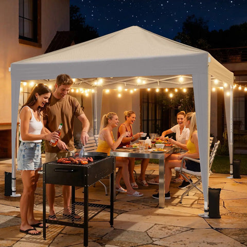Group enjoying a night party under a white 10x10 Pop Up Canopy With Sidewalls For A No Brainer Hassle Free Setup Portable Event Tent