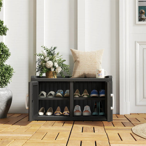 Front view of All-Weather Resin Outdoor Shoe Storage Cabinet With Barn Doors And Entryway Bench black, holding shoes, on patio.