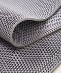Close-up of a grey Grippy Non Slip Drainage Mats PVC Pool Floor Mat 0.23 Inch Thick Outdoor Indoor Parking Space Mat, showing texture.