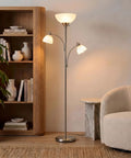 Double LED Floor Lamp With Two Reading Lights Dimmable Torchiere Tall Silver Standing Lamp For Living Room Office And Bedroom Reading Ultra Bright Three Bulb Warm White 3000K next to a bookcase and chair