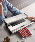 Beast Mode Dual Pump Vacuum Sealer With Dual Sealing Strips And 95KPa 350W Power sealing sausages on a kitchen counter