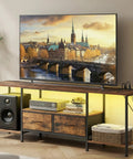 No Sweat Setup Industrial TV Stand With Built In Power Outlets And Chill Led Ambiance Lighting, 70 Inch Media Console For Massive Screens Living Room Storage Shelves Rustic Brown with black speaker and lighted shelves.