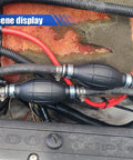Heavy Duty 8mm Manual Primer Bulb Fuel Transfer Pump Works Like A Champ For Gas And Diesel Handles Kerosene Or Water Pulls Clean Each Time Zero Sweat Fits Cars Boats Motorcycles installed in engine compartment showing black hoses and fittings.