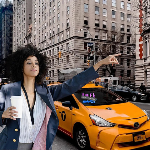 Woman hailing taxi with Dual Color Blue And Pink LED Car Light Sign in urban setting