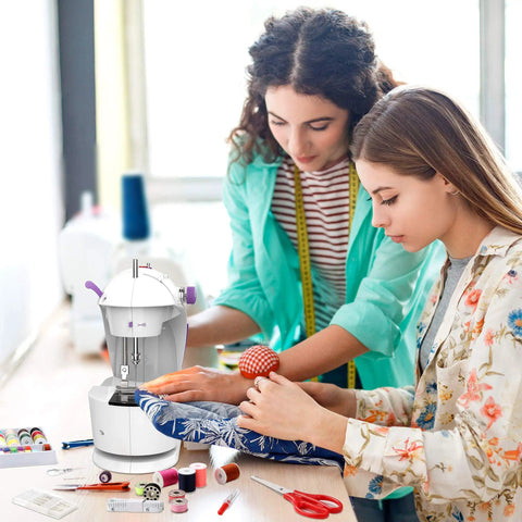 Two people using Beginner Friendly Mini Sewing Machine Kit With Finger Guard and accessory set on fabric project.