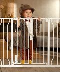Child standing behind Adjustable Baby Gate For Stairs And Doorways From 29.5 To 41.3 Inches Wide, 30 Inches Tall, Extra Wide Auto Close