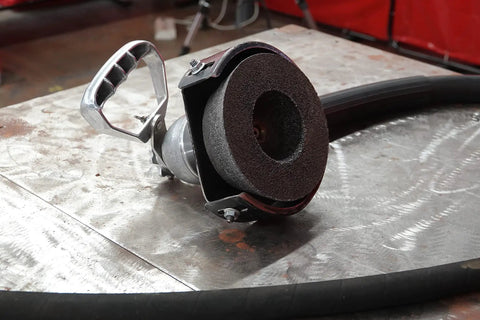 Tiger Ceramic Type 11 Flaring Cup Wheel for metal grinding on a workbench, showing a 1.5 inch rim and smooth vibration-free operation