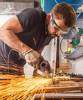 Man using power tool in workshop wearing Bulk Pack Of 96 Pairs Clear Safety Glasses With Six Color Frames For Adults Unisex Eye Protection Goggles