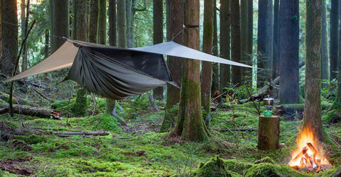 Cub Zip Kids Camping Hammock Hunter Green Side Entry With Full Length Zipper set up in forest with campfire nearby