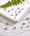 260 Pcs Tibetan Spacer Beads Set 7 Styles Antique Silver Column Tube Metal Spacers For Bracelet Necklace Jewelry Making Hole 1.5 To 3.5 mm Great For DIY Jewelry Projects And Bead Crafts displayed on a tray and wooden surface
