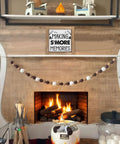 Six Inch Smores Station Sign Wooden Camper Decor for indoor shelf with cozy fire pit setup and marshmallow decor.