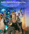 Galaxy Projector Night Light With Remote in use at a vibrant party, projecting starry effects and colorful lights, six-hour battery runtime.
