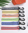 Double Sided Reflective Safety Keychain 4 Pack With Plastic Buckle, in various colors, laid flat on a table.