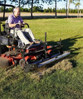 Zero Turn Mower Rake Attachment For Leaves Walnuts Gravel Acorns Grass And More Swinging Toolbar Rake Mounts On Your Black Zero Turn Mower Beefy Yard Cleanup Tool That Makes Debris Pickup A Breeze installed on a mower, raking lawn
